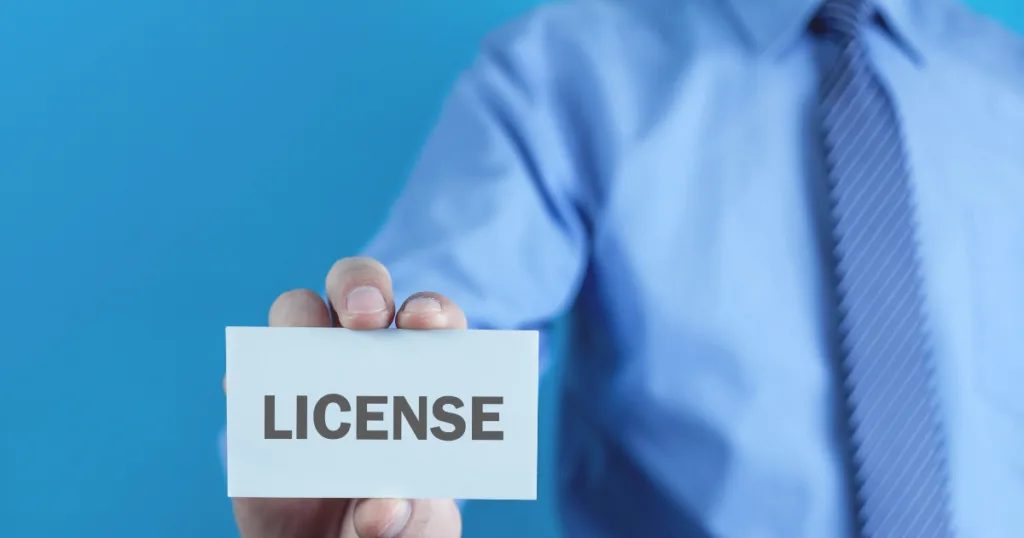 Business professional holding a crypto license card, symbolizing El Salvador Crypto License